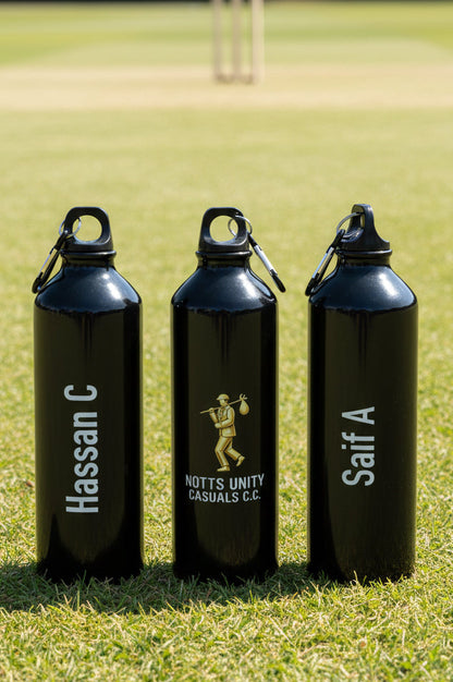 Three black water bottles with names and branding on a grassy field
