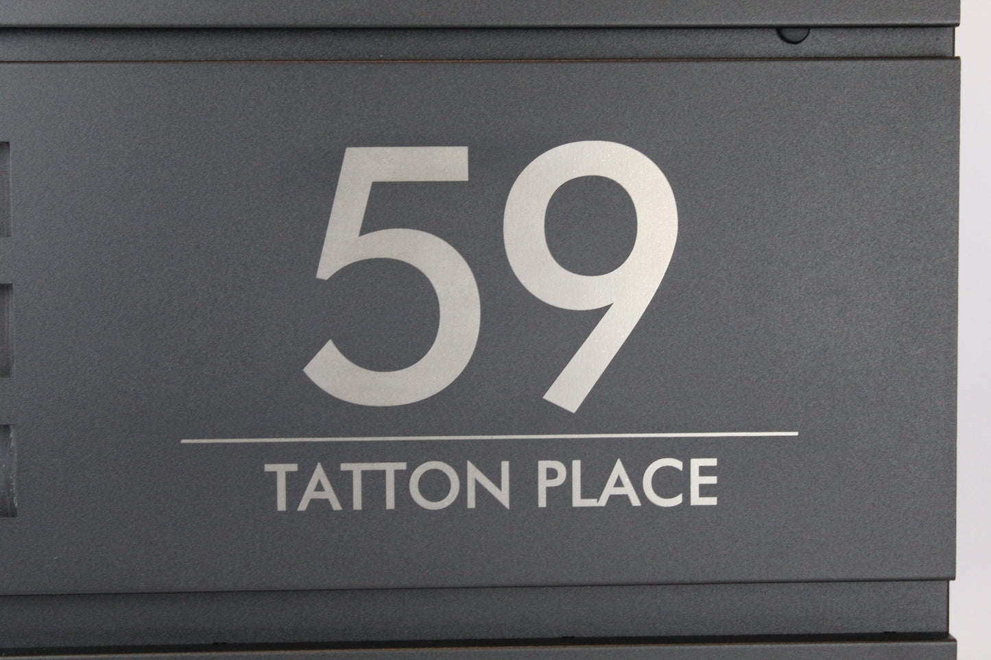 Personalised black mailbox with house number and address engraved
