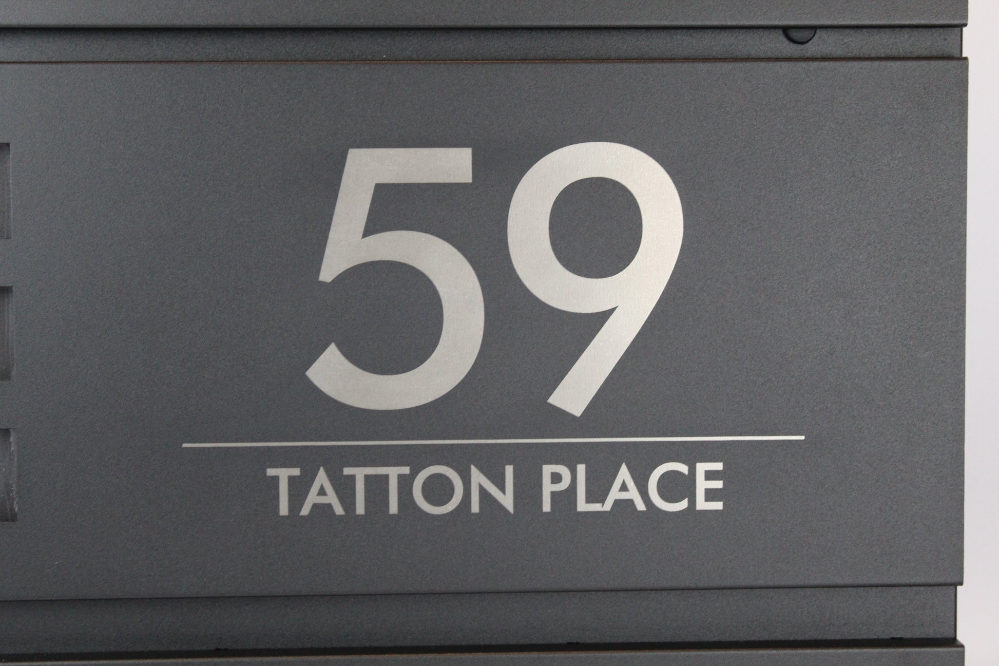Personalised black mailbox with house number and address engraved
