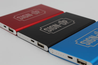 Three power banks in red, black, and blue with 'SIGN-UP' text on a light gray background